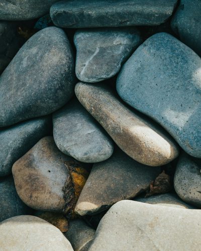 Photo of flat smooth rocks, close up, flat lay photography, unsplash --ar 51:64