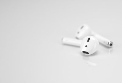 Photo of AirPods on a white background, high quality photo, in the style of unsplash photography, minimalistic style. --ar 128:87