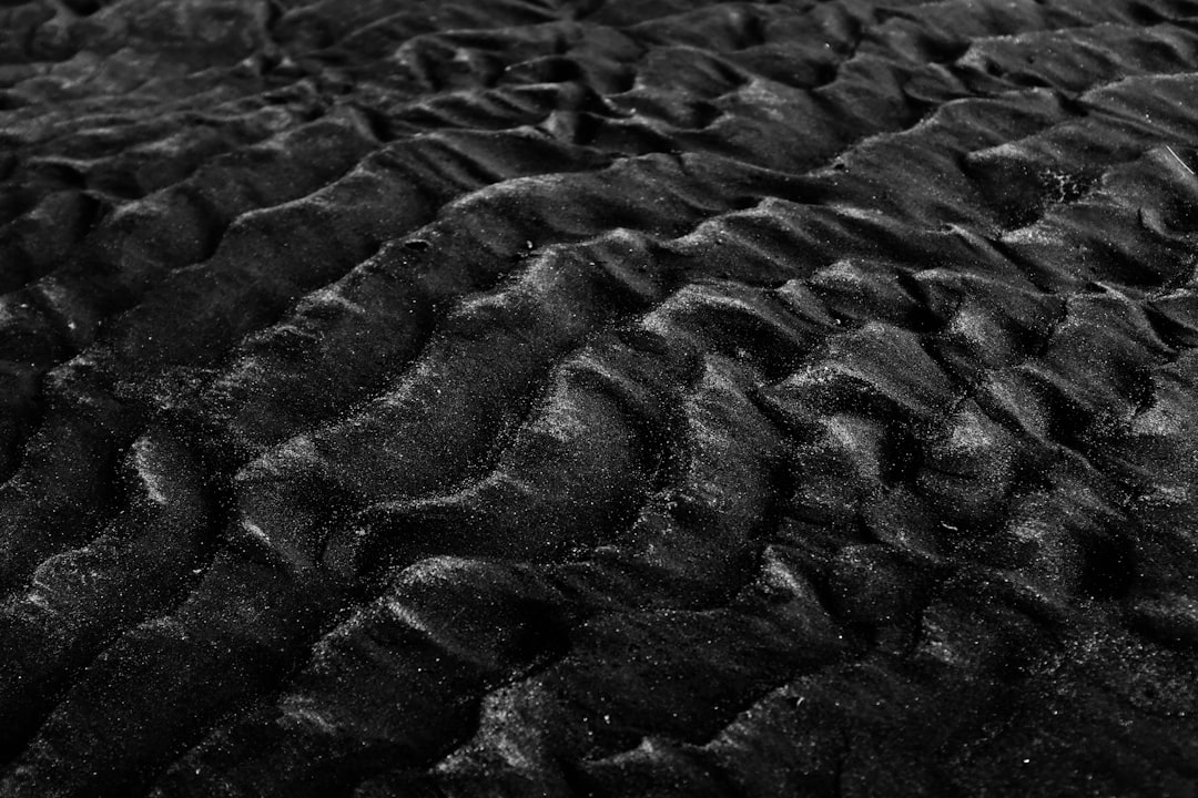 black sand texture, dark black beach, black and white, close up, macro photography, low contrast –ar 128:85