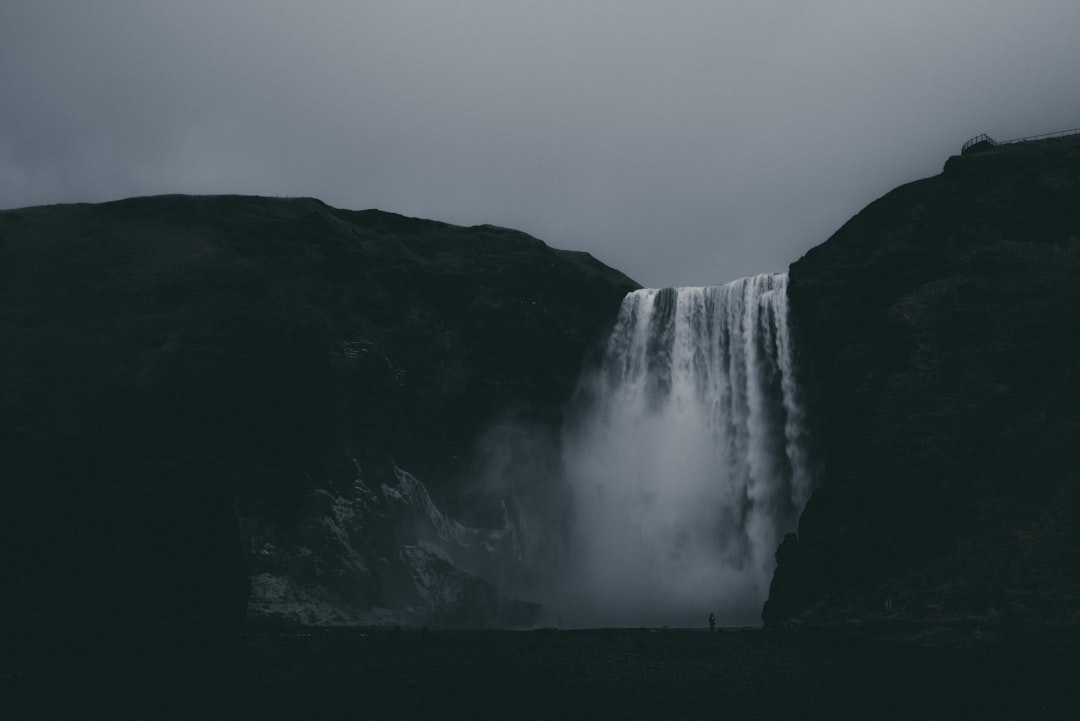 Black and white minimalist photography of the waterfall in Iceland, in the style of unsplash, dark and moody. –ar 128:85