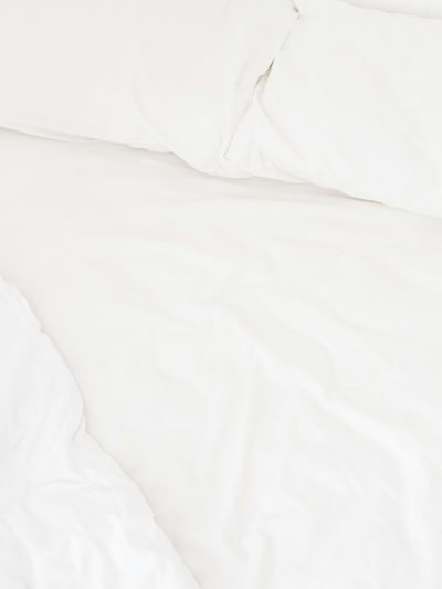 White bed linen, closeup, simple white background, minimalist, high resolution photography, professionally color graded, soft shadows, no contrast, clean sharp focus, focus stacking, digital photography. --ar 3:4