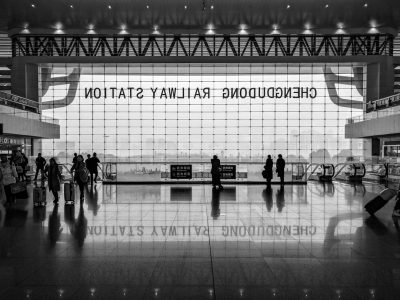 Chinese airport terminal, large glass windows with the word "Copyright" written on it in black and white, people walking around, cinematic, documentary photography style, wideangle lens, natural light, busy atmosphere, cityscape background. In the style of documentary photography. --ar 4:3