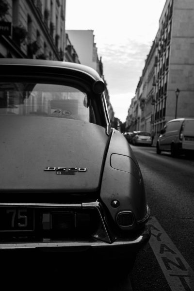 close up of front end view, black and white photograph of an open roofed grey ", peugeot" citroen by [Dieter Rams](https://goo.gl/search?artist%20Dieter%20Rams) in the streets of paris , golden hour, cars passing by in background, hasselblad camera --ar 85:128