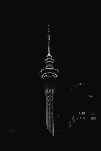 black and white photo of the sky tower in new zealand, night time, high contrast, minimalistic, black background, cinematic, artful, professional photography, high resolution, canon r5 --ar 85:128