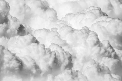 Black and white fluffy clouds in the sky. Aerial view of beautiful white puffy clouds on grey background. Cloudy abstract background. High resolution photography, high detail, hyper realistic, national geographic photo, hyper detailed, super resolution --ar 128:85