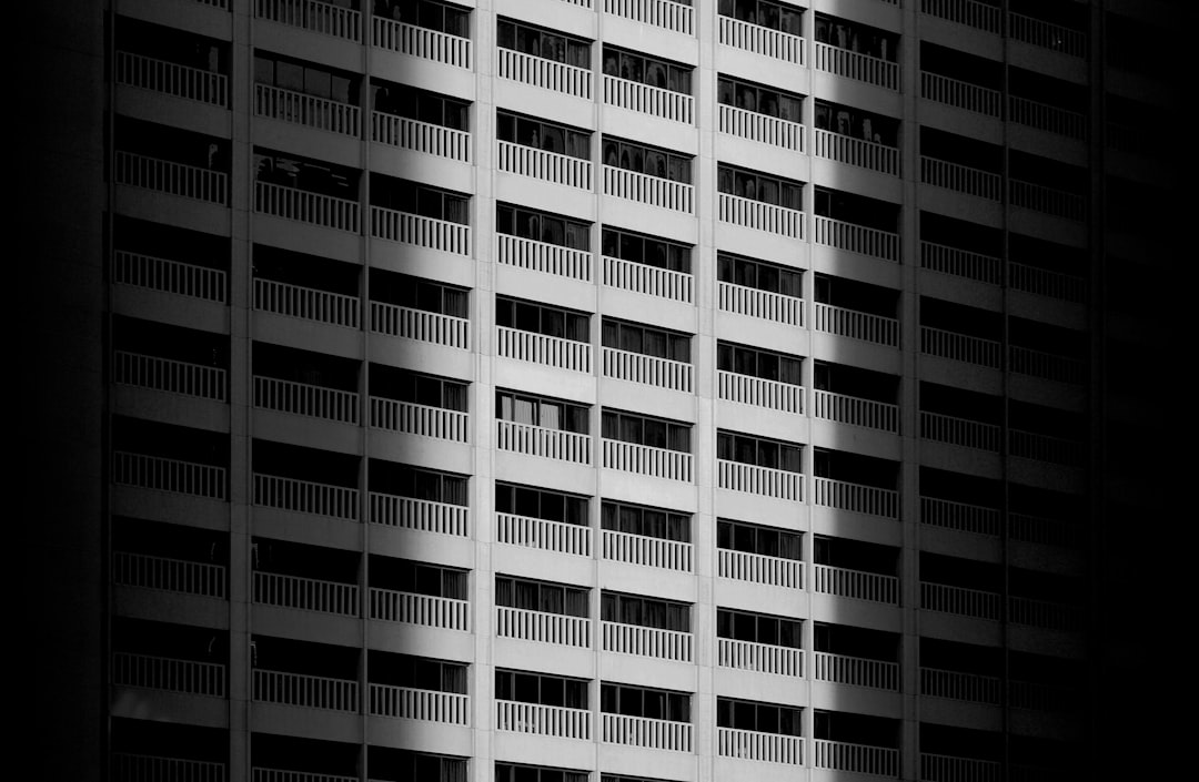 Black and white photography of the facade from an apartment building in Bangkok, minimalism, pattern, sunlight –ar 128:83