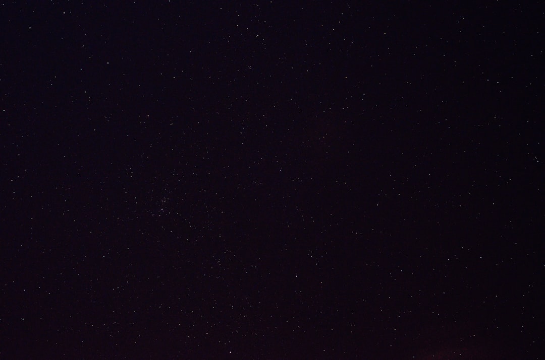 night sky, black background, no stars, taken from the ground, wide angle view. Shots were taken in the style of Anthropic from the ground with a wide angle lens, showing a black night sky with no visible stars. –ar 32:21