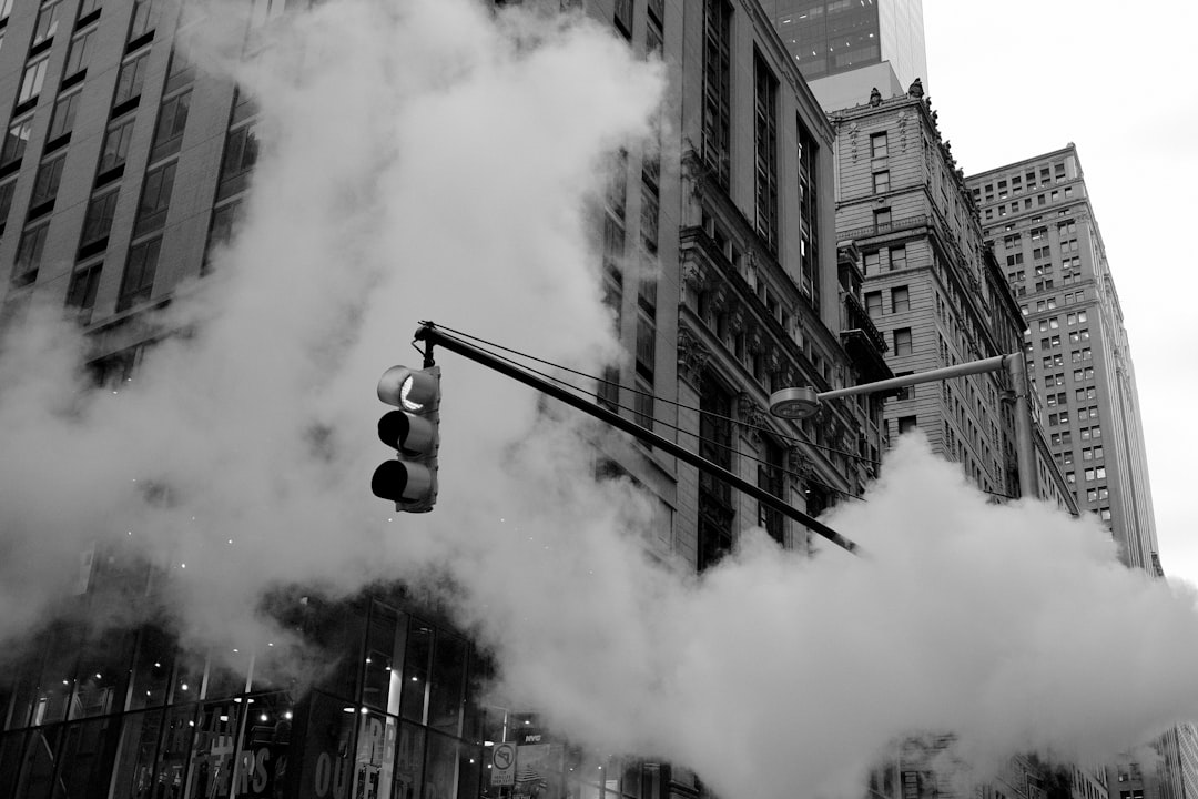 photo of traffic light in smoke, buildings in background, black and white, low angle shot, New York City, street photography in the style of [Fan Ho](https://goo.gl/search?artist%20Fan%20Ho) –ar 128:85