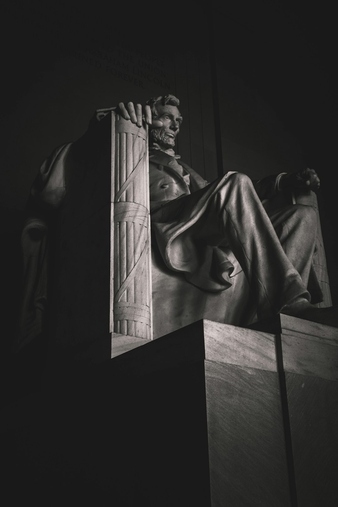 Black and white photo of the Abraham Lincoln sculpture in Washington DC, sitting on top of an open door at night, backlit, f/24, 35mm lens, high contrast, chiaroscuro lighting in the style of [Rembrandt](https://goo.gl/search?artist%20Rembrandt). –ar 85:128