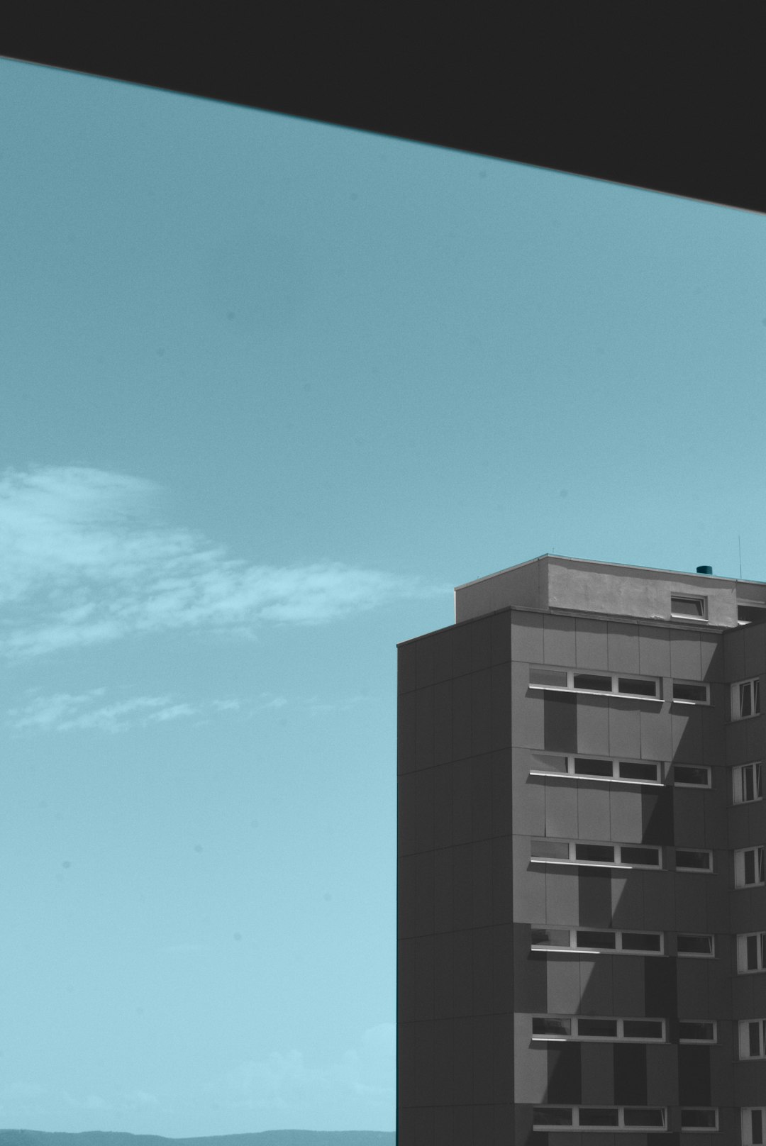 A minimalistic photo of an apartment building, the sky is blue and clear, in the style of [Hiroshi Sugimoto](https://goo.gl/search?artist%20Hiroshi%20Sugimoto) photography, the photo was taken from inside looking out through a window, only one colour on screen, shot with a Leica M6 camera using 35mm film. –ar 85:128