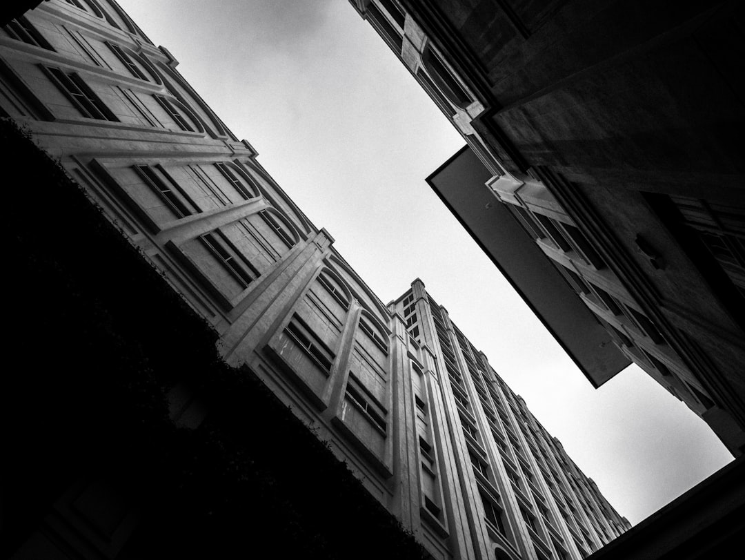 black and white photography, wide angle shots, art deco architecture captured from street level, looking up in the style of the architecture. –ar 4:3