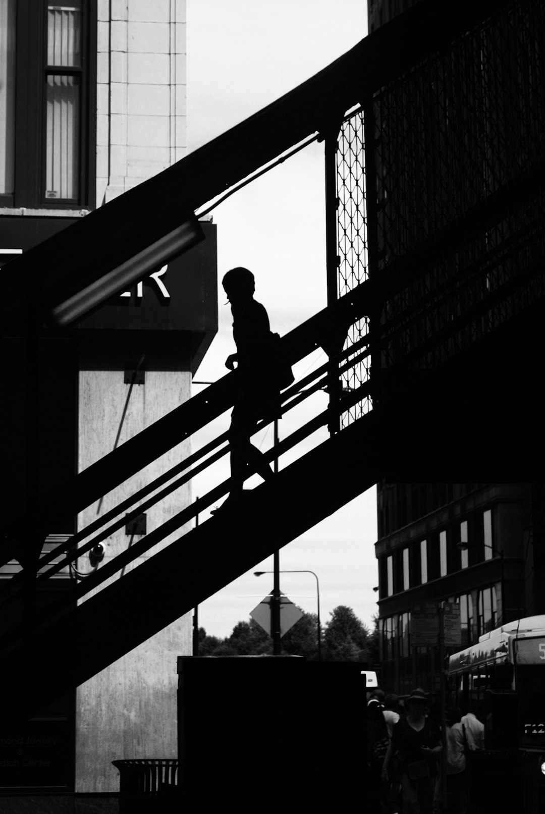 Black and white photography of a silhouette man walking up the stairs in Berlin, street life scenes, city portraits, street level views. –ar 85:128