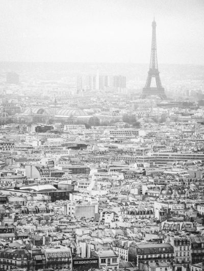 Paris, black and white, aerial view, vintage photography, Eiffel Tower in the distance, old buildings, cityscape, Leica M6 with SummiluxM 50mm f/2 ASPH lens, soft light, Parisian charm, misty morning, grey sky, city lights, bustling streets, romantic atmosphere. --ar 3:4
