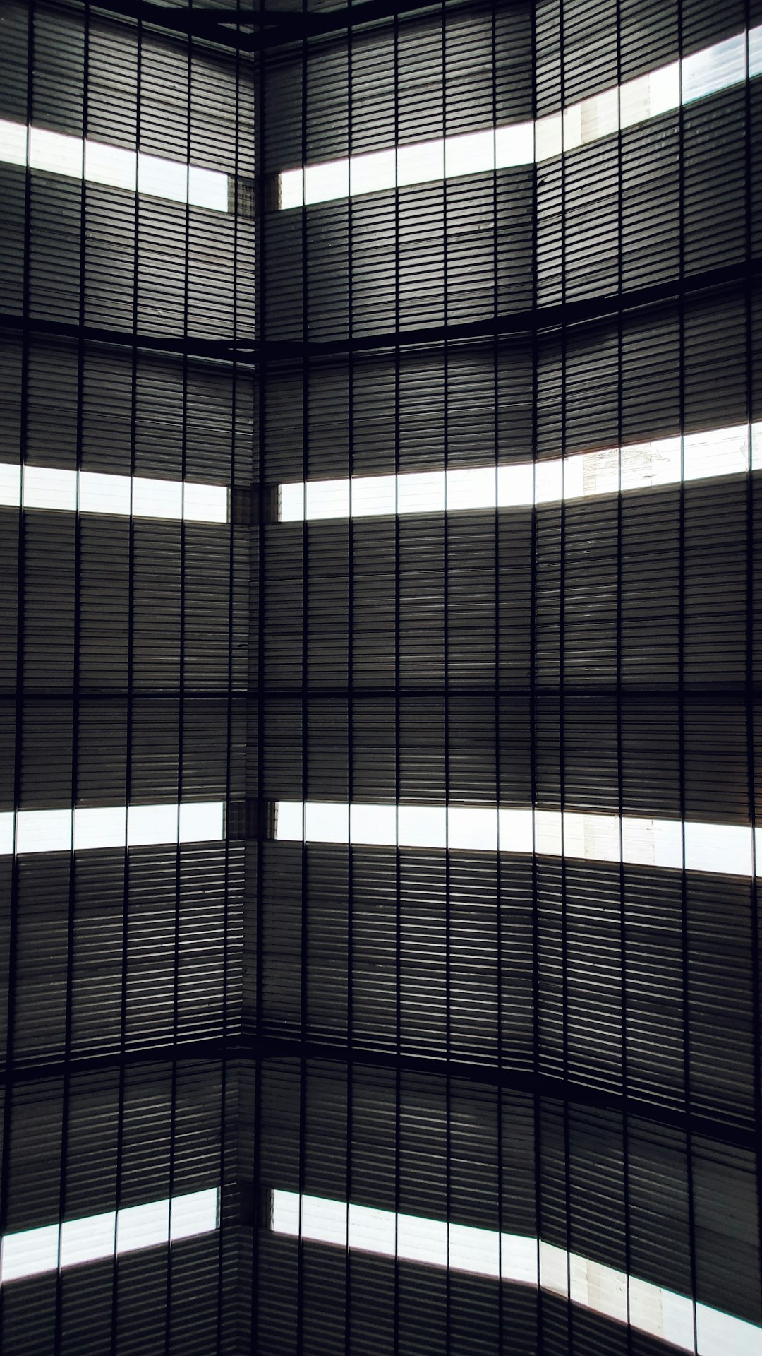 Black metal slats, vertical stripes of light shining through, inside the glass ceiling of an art museum in Tokyo. Minimalist background, high resolution, hyper realistic photography, award winning photo –ar 9:16