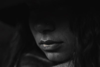 A closeup of the face, focusing on her lips and nose, illuminated by soft moonlight, creating an atmosphere. The monochromatic color scheme adds depth to the composition. --ar 128:85