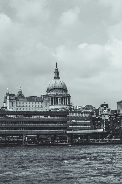 St Paul's Cathedral in London, seen from the river Thames, vintage black and white photography, grainy, lo-fi style, high contrast, low saturation, in the style of H.R plate, unsplash, hyper realistic --ar 85:128