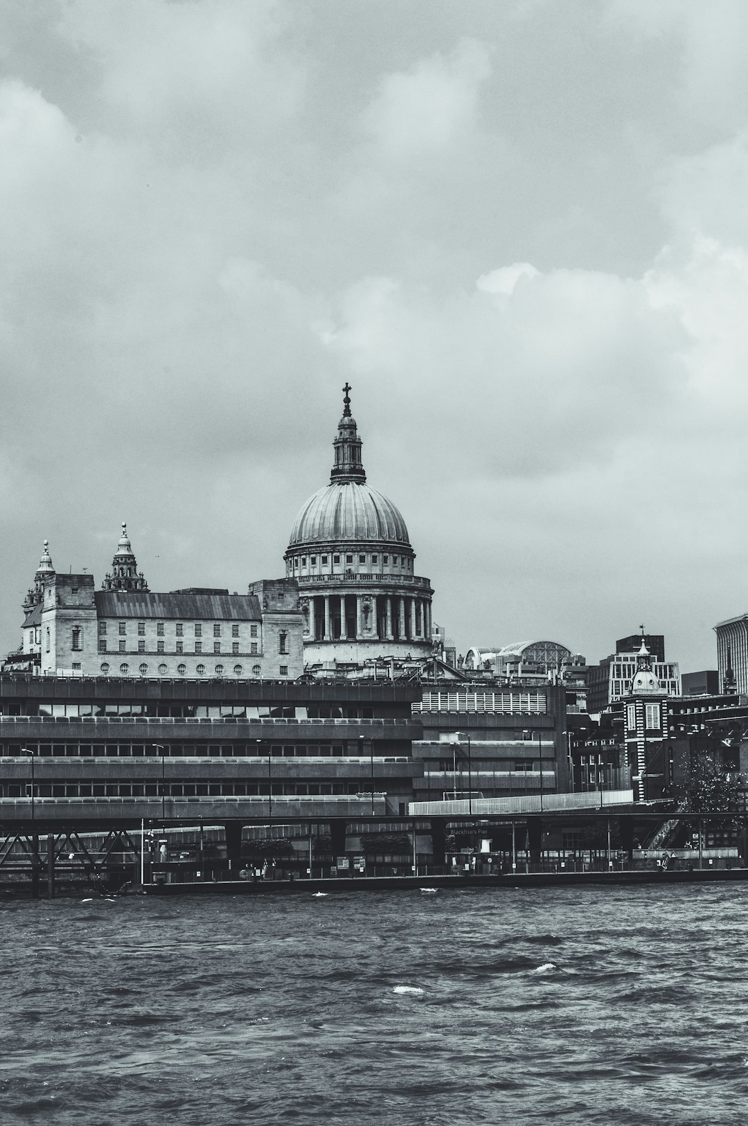 St Paul’s Cathedral in London, seen from the river Thames, vintage black and white photography, grainy, lo-fi style, high contrast, low saturation, in the style of H.R plate, unsplash, hyper realistic –ar 85:128