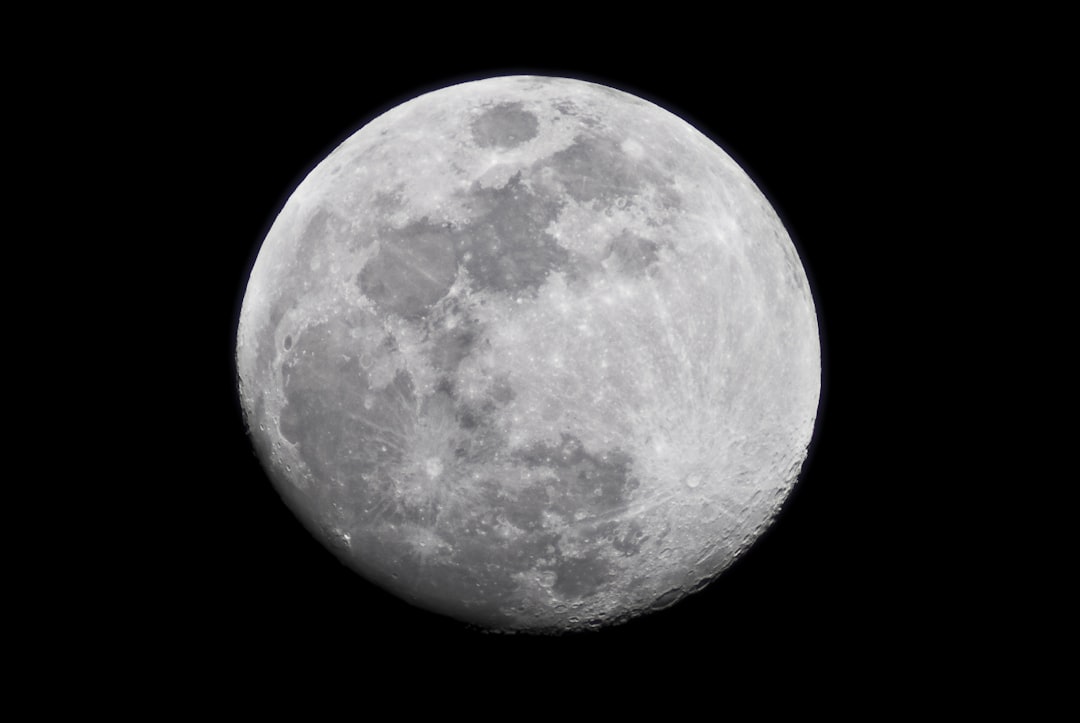 A photo of the moon taken with an iPhone, isolated on a black background, in high resolution with very details. The photo is in the style of an iPhone camera but in high quality and isolated on a plain black background. –ar 128:85