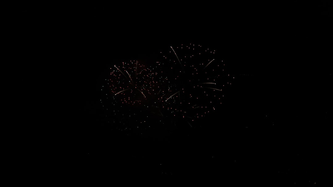 A fireworks display in the night sky, pure black background, high resolution photography, professional color grading, soft shadows, clean sharp focus, film grain effect. The photography has a style similar to in the style of professional photographers with soft shadows and clean sharp focus. –ar 128:71