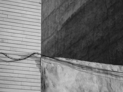 Black and white photography of an electric wire on the side wall, --ar 4:3