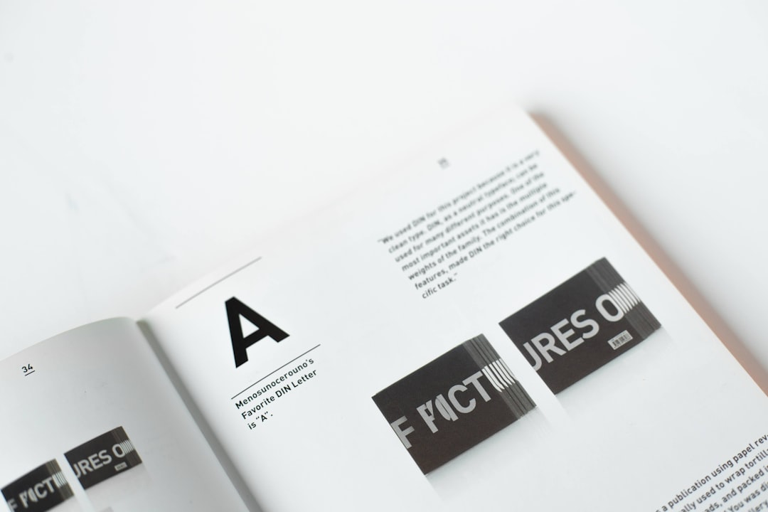 A graphic design book page features the text “F determining” in bold black letters on a white background. There is an icon of two A’s and one C on the top right corner of the document. The overall aesthetic should be minimalist with clean lines and geometric shapes, reflecting a modernist style with a white paper background, minimalistic typography, and high resolution in the style of modernist designers. –ar 128:85