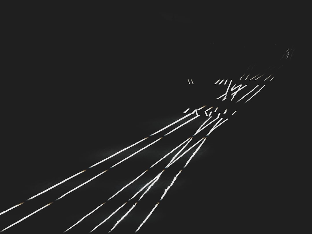 long straight lines of light on a black background, drawing in the style of Long. Thin long stripes of light in the shape of lights with some big white dots, minimalistic. –ar 4:3