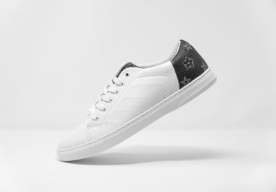 Sneaker mockup with Louis Vuitton monogram print, white leather upper and black star patterned sole on a clean background, perfect for showcasing brand identity in fashion product photography, high resolution, with copy space --ar 128:89