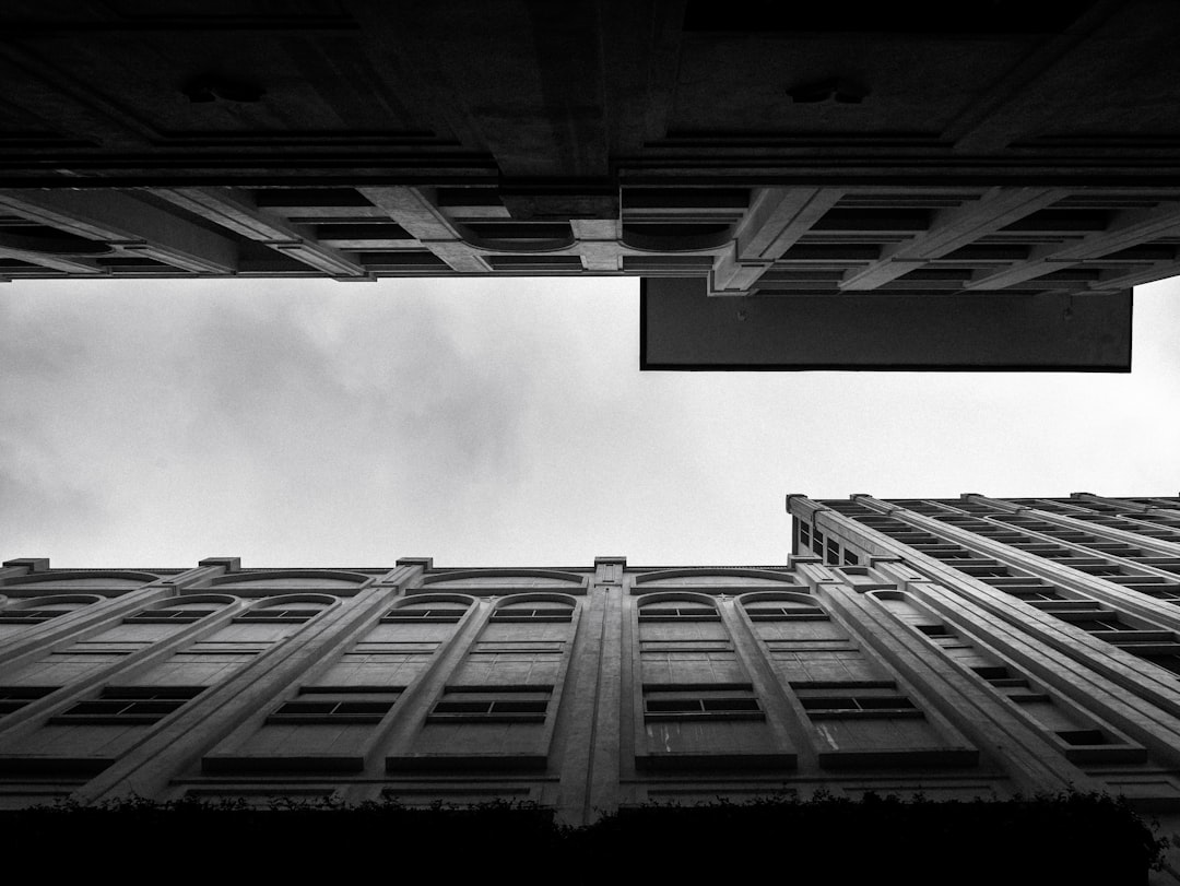 Black and white photography of architecture in San Francisco, taken from below looking up at the building’s facade. The sky is overcast. The photograph was taken in the style of [Ansel Adams](https://goo.gl/search?artist%20Ansel%20Adams). –ar 4:3