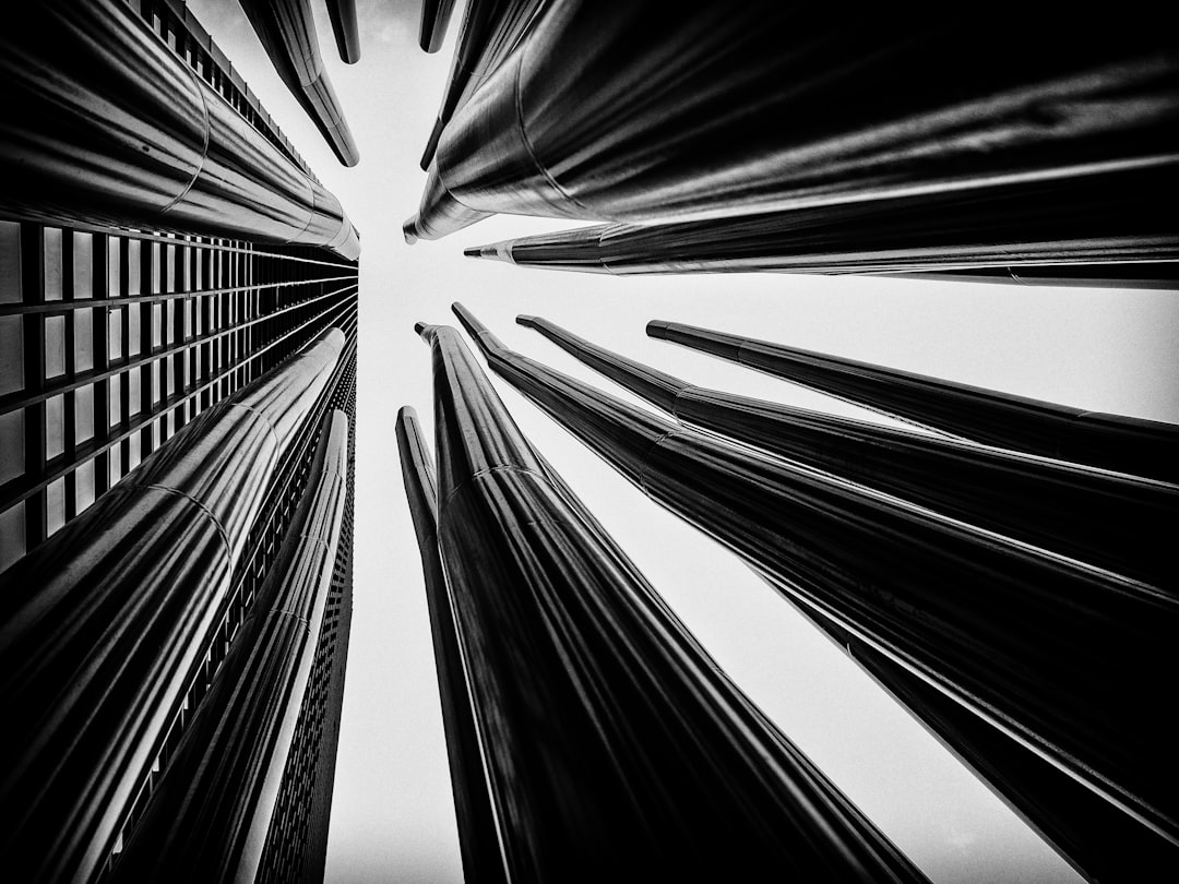 Black and white photography, perspective of skyscrapers that look like long thin canes pointing upwards from a low angle shot, taken with a Canon EF 24-70mm f/2.8L III lens in the style of typical city photography. –ar 4:3