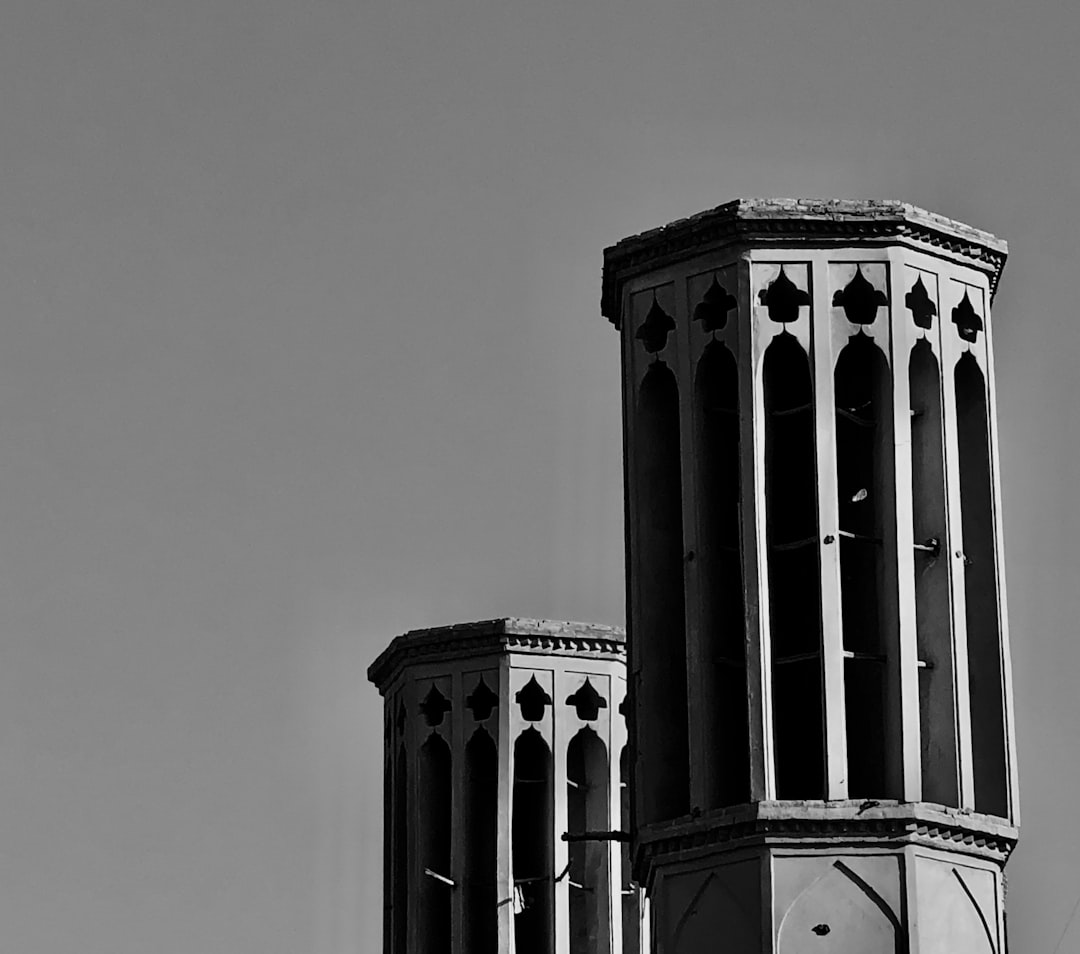 photograph of two persian wind towers, in black and white, with high contrast, on a simple background, architecture photography, with detailed –ar 128:113