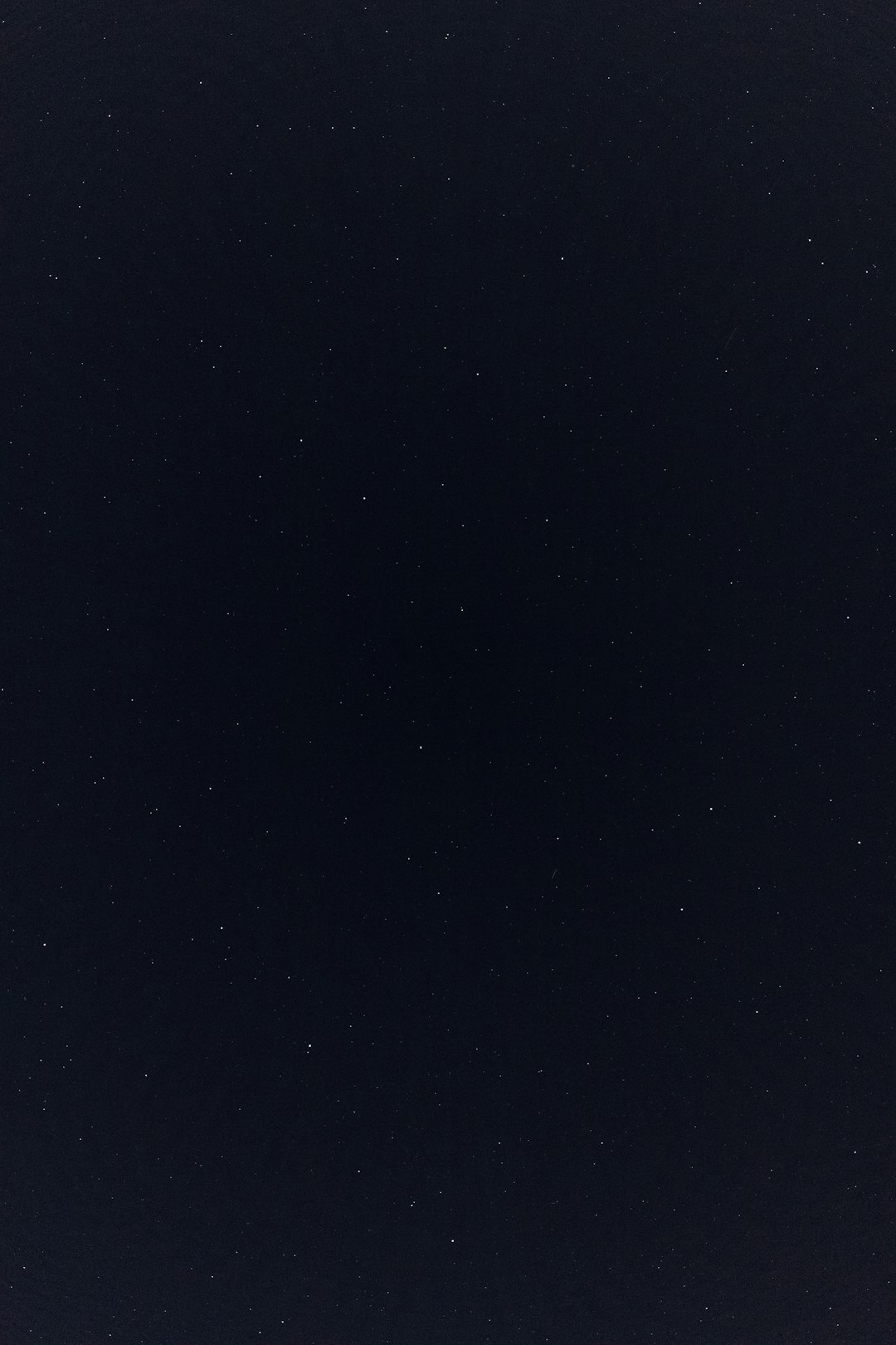 A flat, dark blue sky without any stars or other objects. The background is completely black and uniform in color with no patterns or textures visible on the surface of it. There’s nothing else but for one small star to be faintly illuminated at the bottom right corner of frame. This creates an atmosphere of solitude and calmness. It would work well as a background texture for various creative projects that need a minimalist yet striking effect. –ar 85:128