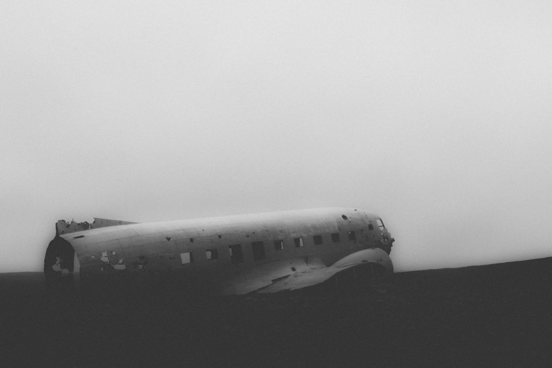 black and white photography of the crashed plane in Iceland, foggy weather, minimalist, cinematic –ar 128:85