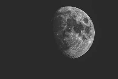 The moon is half drawn in the sky, in grayscale with high contrast and a simple background. The photograph has high resolution and appears to be professionally taken, in the style of HDR black and white photography using a Canon EOS camera with an f/8 lens. --ar 128:85