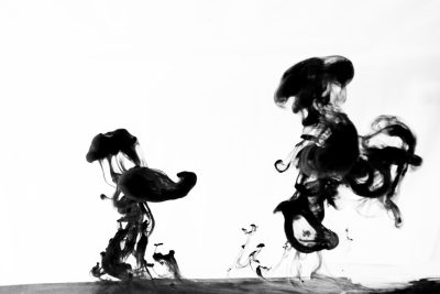 Ink clouds and ink strokes on a white background with dark gray and black ink colors. Ink fluidity is shown with two jellyfish-shaped figures dancing in the air in an abstract art style. An ink spreading effect is used with a surrealistic composition that has a high contrast between light and shadow for a strong visual impact. --ar 128:85