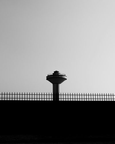 minimalist black and white photography of the space needle in seattle, on top of an iron fence, simple composition, high contrast, high resolution, sharp focus, rich details, taken with Nikon D850 camera using Nikon AFS NIKKOR 2470mm f/2.6E ED VR lens --ar 51:64