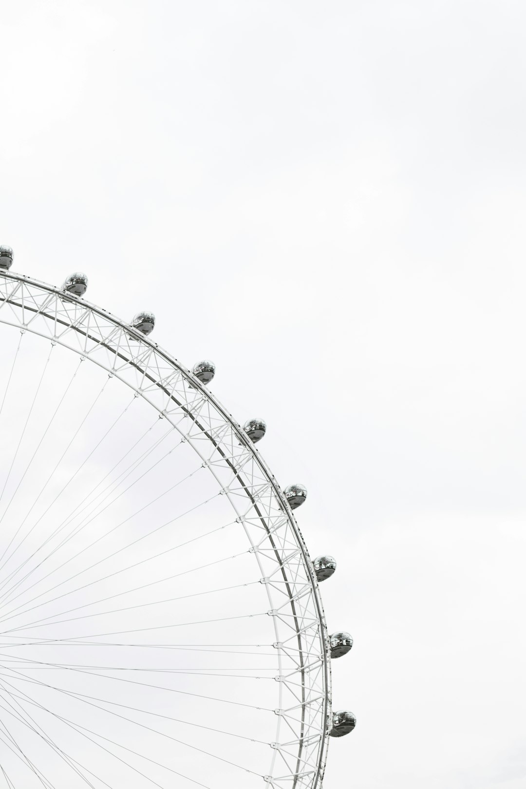 White background, minimalist style, London eye, simple composition, high resolution photography, large aperture, closeup of the Ferris wheel with white sky in the foreground, black and gray tones, clear details, and no characters on it. in the style of London eye. –ar 85:128