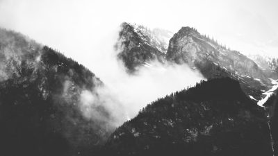 Black and white photography of mountains with fog, highly detailed, high resolution, shot in the style of Sony A7R III. --ar 16:9