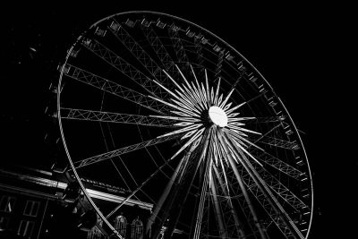 Ferris wheel at night, low angle, high contrast, black and white photography, in the style of street style --ar 128:85