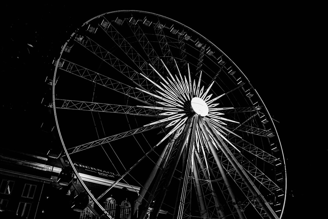 Ferris wheel at night, low angle, high contrast, black and white photography, in the style of street style –ar 128:85