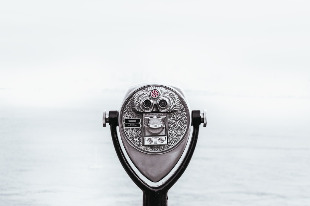 A gray coin viewer with the ocean in view, white background, minimalistic –ar 128:85