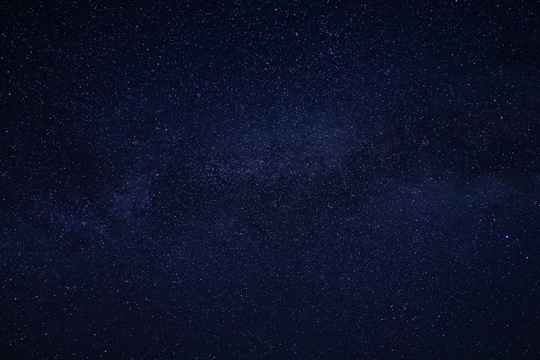A dark night sky full of stars was captured in high resolution. The background is a dark blue with no other elements visible except for the starry sky. It is a wide shot, taken from an eye-level perspective, showcasing the vastness and beauty of space. This photo was created using a Sony Alpha A7 III camera and has a high level of detail. The style of the photo is reminiscent of works in the style of artists who capture the beauty and vastness of space. –ar 128:85