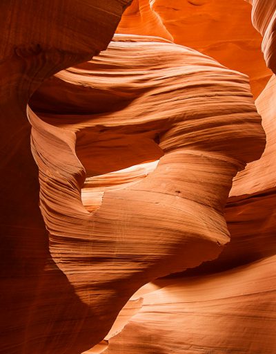 low angle photo of the inside of Antelope Canyon, a sandstone canyon in Lake Steak Mountain, Arizona with red and orange rock formations, warm lighting, smooth curves and sharp turns, close up, shot on Canon EOS5D Mark III camera --ar 25:32