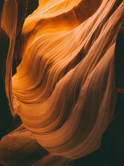 A close up of the inside wall of Antelope Canyon in Arizona, a natural formation with waves and curves, warm lighting during the golden hour, shot on a Canon EOS R5 in the style of the artist. --ar 95:128