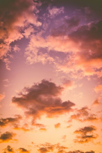 photo of a beautiful sky with a sunset, purple and orange clouds, low angle shot, in the style of unsplash photography --ar 85:128