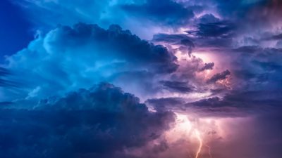 A dramatic sky with dark storm clouds and lightning, creating an intense atmosphere. , blue purple lighting, detailed photo --ar 16:9