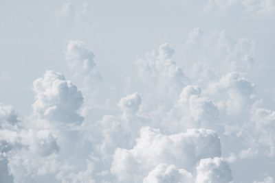 Photo of Clouds in the sky, captured in the style of Canon EOS. White color background. Soft light. A photo taken from above with lots of white clouds. The white clouds form an abstract shape that resembles water droplets or snowflakes. It is a simple and elegant composition. There should be no shadows on it, and there will not be any text on top of them. This is a real photograph taken using professional cameras, with a shallow depth of field. --ar 128:85