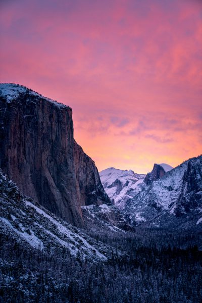 Yosemite National Park, snow-covered mountains under the pink sunset sky, in the style of Nikon D850. --ar 85:128