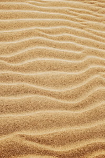 Beautiful sand texture background, desert pattern. Sand dunes, golden ripples of wind on the beach. --ar 85:128