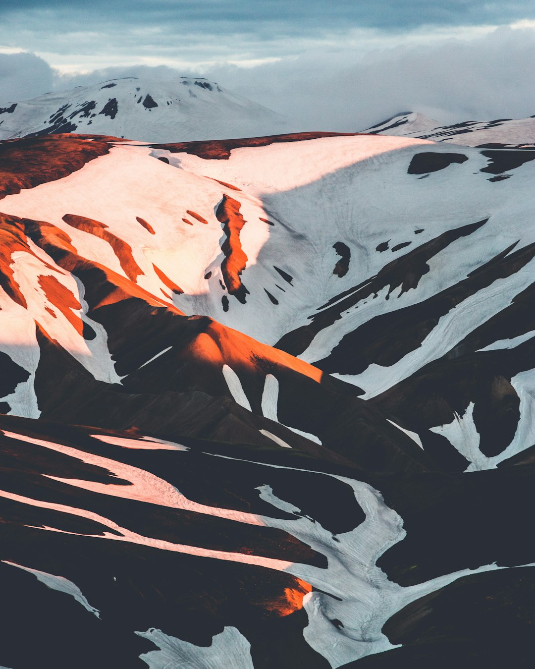 Iceland, mountains with snow and orange shadow, top view, photo realistic, photography, in the style of canon eos r5 –ar 51:64