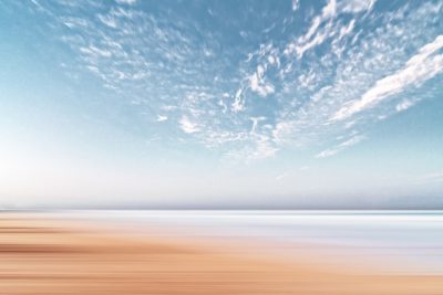 Beautiful seascape, sky and beach in motion blur, minimalism, pastel colors, neutral tones, calm and peaceful atmosphere, beautiful sky with white clouds, wide angle, natural light, professional photography, sharp focus, high resolution --ar 128:85